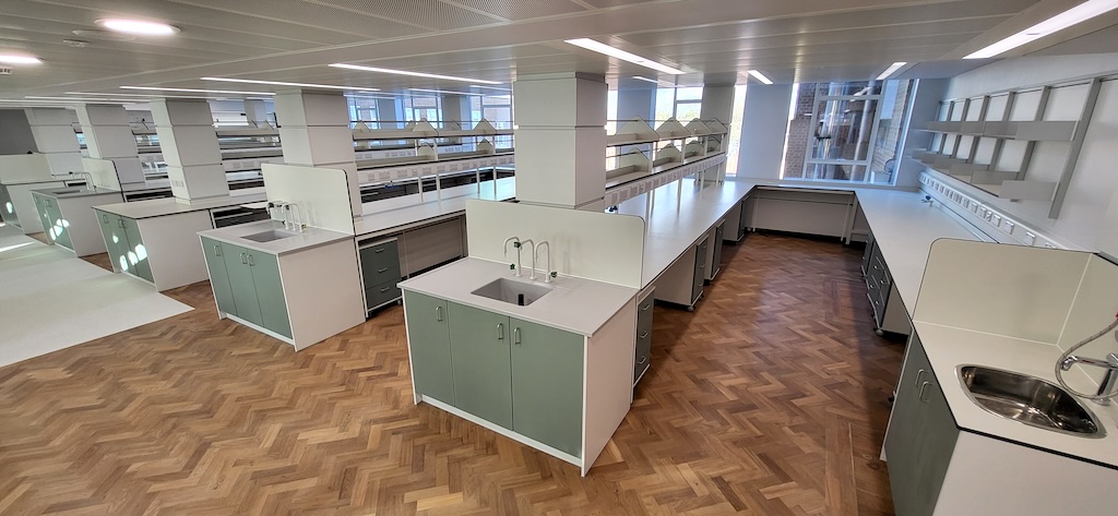 This large project at the prestigious University of Cambridge involved both the installation of new flooring as well as the restoration of existing floors in their Department of Chemistry. Our works included the sanding, filling of the beautiful, old herringbone parquet floor there, finishing with a specialist high-traffic seal. We then installed specialist Safety flooring in sheet vinyl form to laboratories and Nordic Stories carpet tiles (with overall 59% recycled content) to offices.