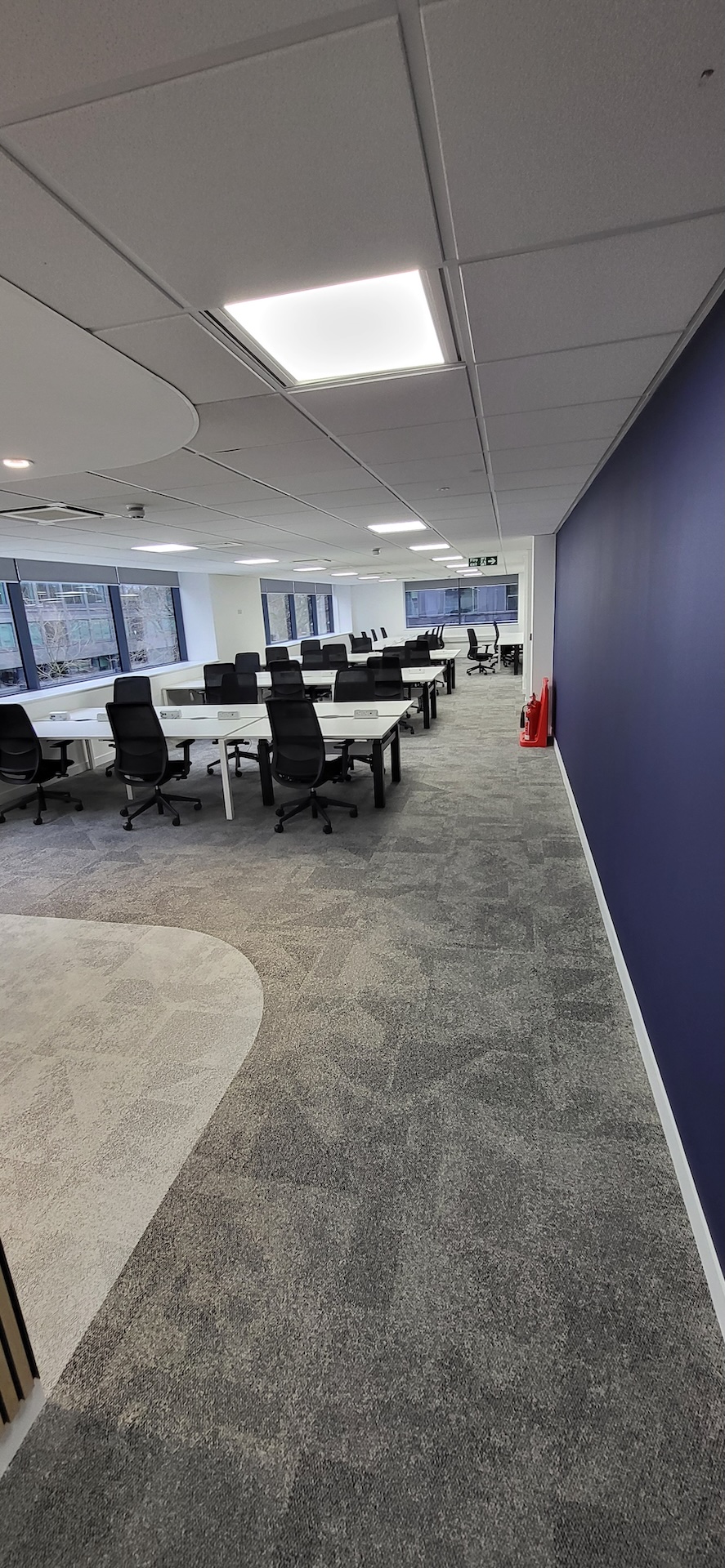 We were invited to work on this project with Main Contractors AIS, near to Blackfriars Bridge. The installation included Paver carpet tiles (with an 84% recycled content), Terazzo vinyl tiles, which have an attractive stone-effect embossing, and Spacia wood-effect LVT.

The areas for LVT installation required careful preparation. Firstly, the existing concrete subfloor was thoroughly cleaned, after which our team applied a specialist smoothing compound to achieve a fine surface for ready for the LVT planks to be installed through the corridor and refreshment points - and to achieve the best transition between the carpet and LVT.

Finally, a new entrance matwell was installed to prevent the ingress of dirt and keep the floors looking pristine.