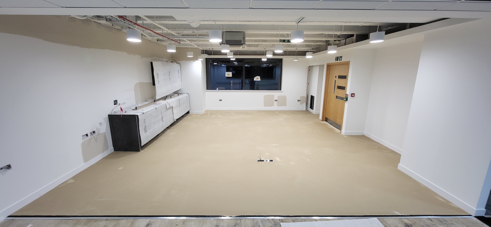 We were invited to work on this project with Main Contractors AIS, near to Blackfriars Bridge. The installation included Paver carpet tiles (with an 84% recycled content), Terazzo vinyl tiles, which have an attractive stone-effect embossing, and Spacia wood-effect LVT.

The areas for LVT installation required careful preparation. Firstly, the existing concrete subfloor was thoroughly cleaned, after which our team applied a specialist smoothing compound to achieve a fine surface for ready for the LVT planks to be installed through the corridor and refreshment points - and to achieve the best transition between the carpet and LVT.

Finally, a new entrance matwell was installed to prevent the ingress of dirt and keep the floors looking pristine.
