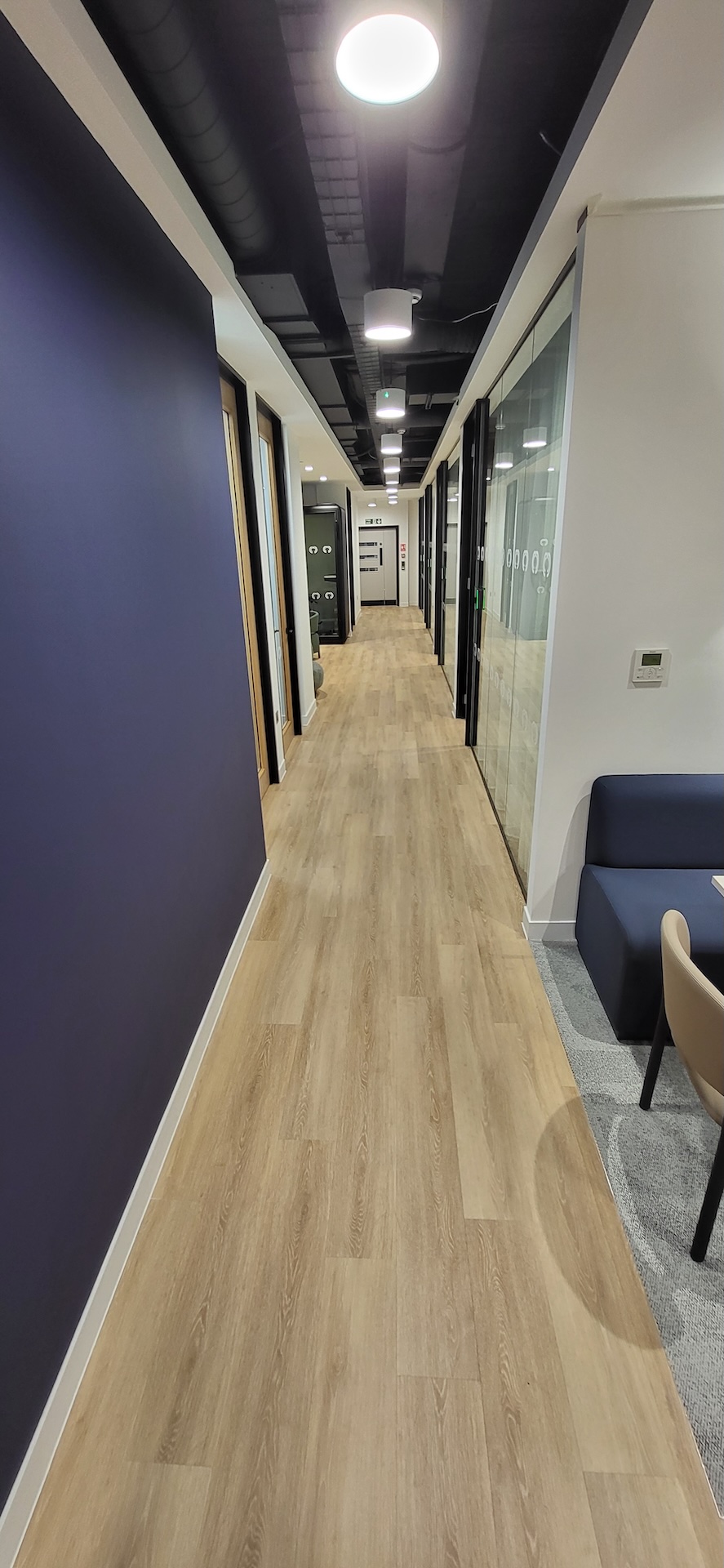 We were invited to work on this project with Main Contractors AIS, near to Blackfriars Bridge. The installation included Paver carpet tiles (with an 84% recycled content), Terazzo vinyl tiles, which have an attractive stone-effect embossing, and Spacia wood-effect LVT.

The areas for LVT installation required careful preparation. Firstly, the existing concrete subfloor was thoroughly cleaned, after which our team applied a specialist smoothing compound to achieve a fine surface for ready for the LVT planks to be installed through the corridor and refreshment points - and to achieve the best transition between the carpet and LVT.

Finally, a new entrance matwell was installed to prevent the ingress of dirt and keep the floors looking pristine.